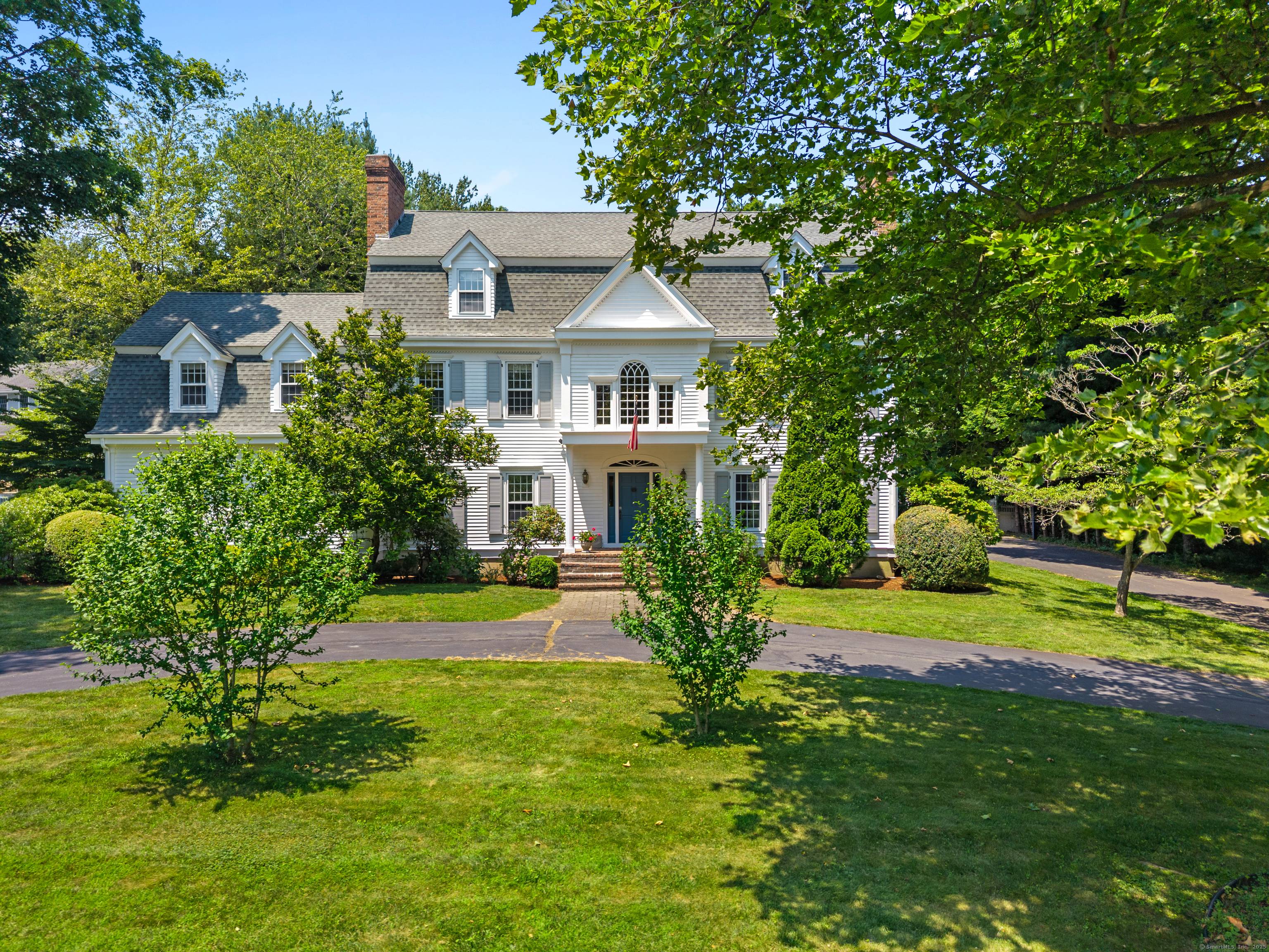 A stately circular driveway ushers you into a realm of elegance comfort.