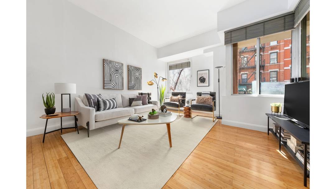 Parlor Floor Townhouse Living with Full Service Condominium Amenities Expansive, freshly painted, and filled with natural light, this parlor floor Junior 4, set above the bustling street, offers the rare ...