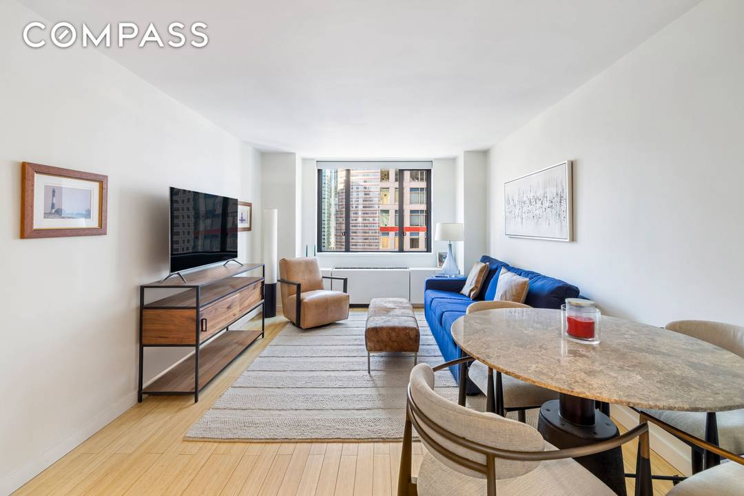 Located high above coveted Sutton Place, this meticulously updated one bedroom residence captures sweeping south facing city views, showcasing a dramatic New York skyline highlighted by the new JP Morgan ...