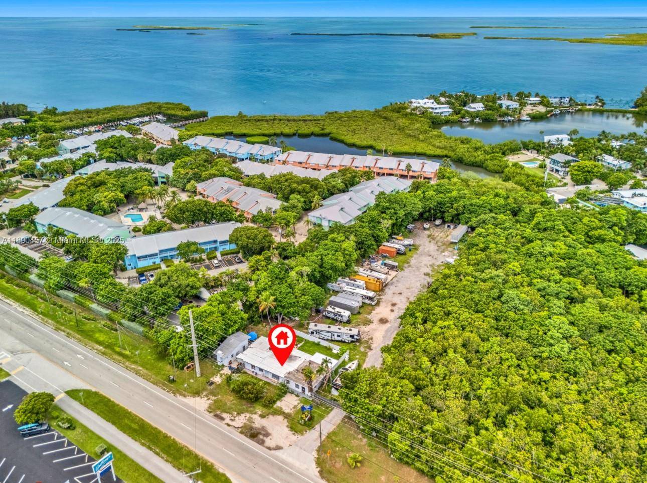 INCREDIBLE OPPORTUNITY ! 125 feet of Road frontage on Overseas Highway Storage Yard Facility with Marina License located on the Bay Side Property has many improvements including office building and ...