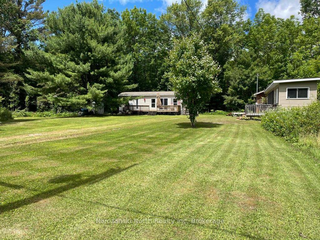 Own a private, two acre retreat on a beautifully level lot where ATV and snowmobile trails are just a stones throw away.