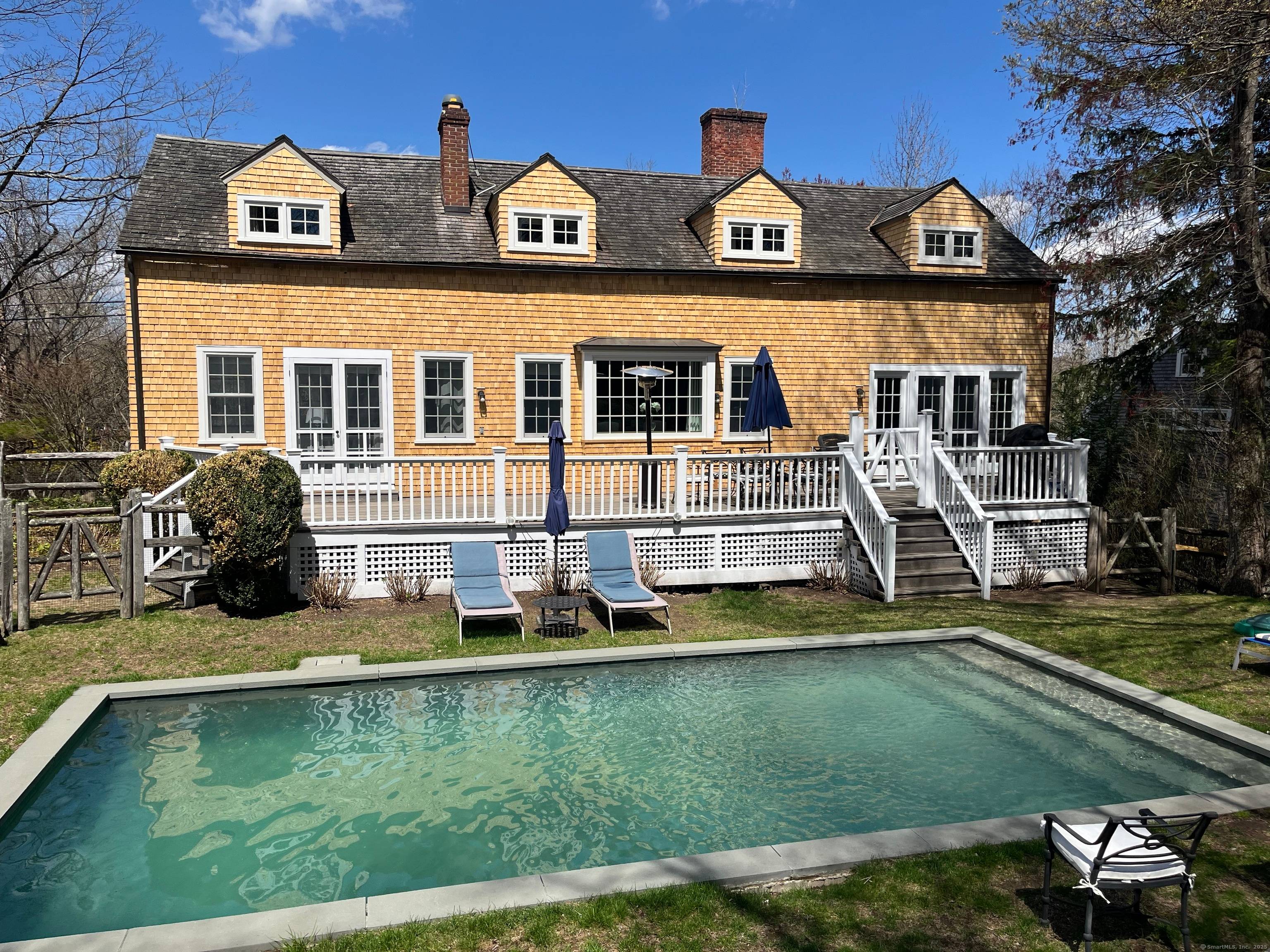 Restored country cottage furnished with antiques, fine furnishings oriental rugs.
