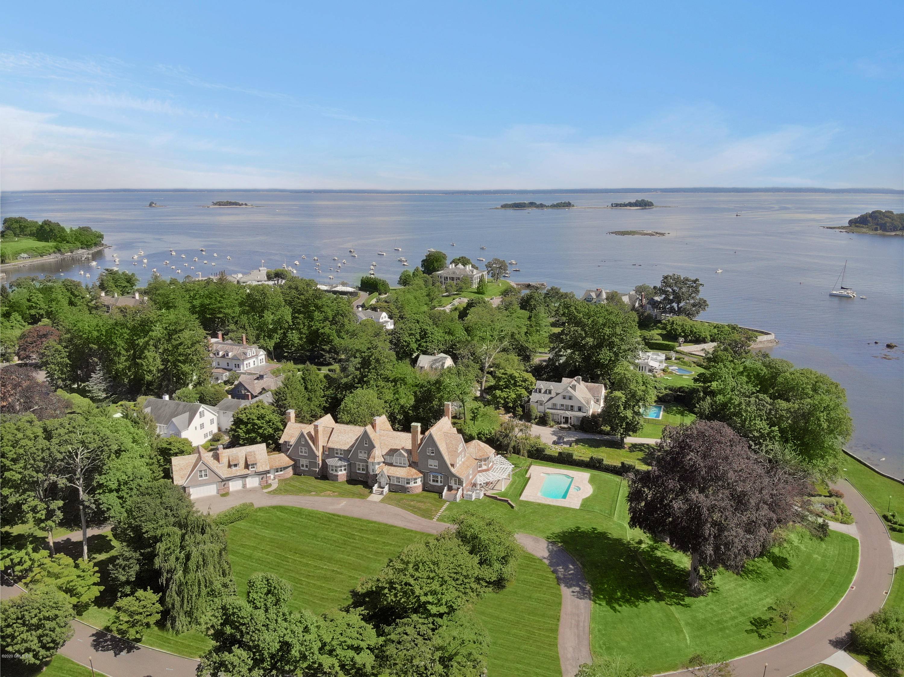 Belle Haven Newport style stone shingle masterpiece perched high on 2.