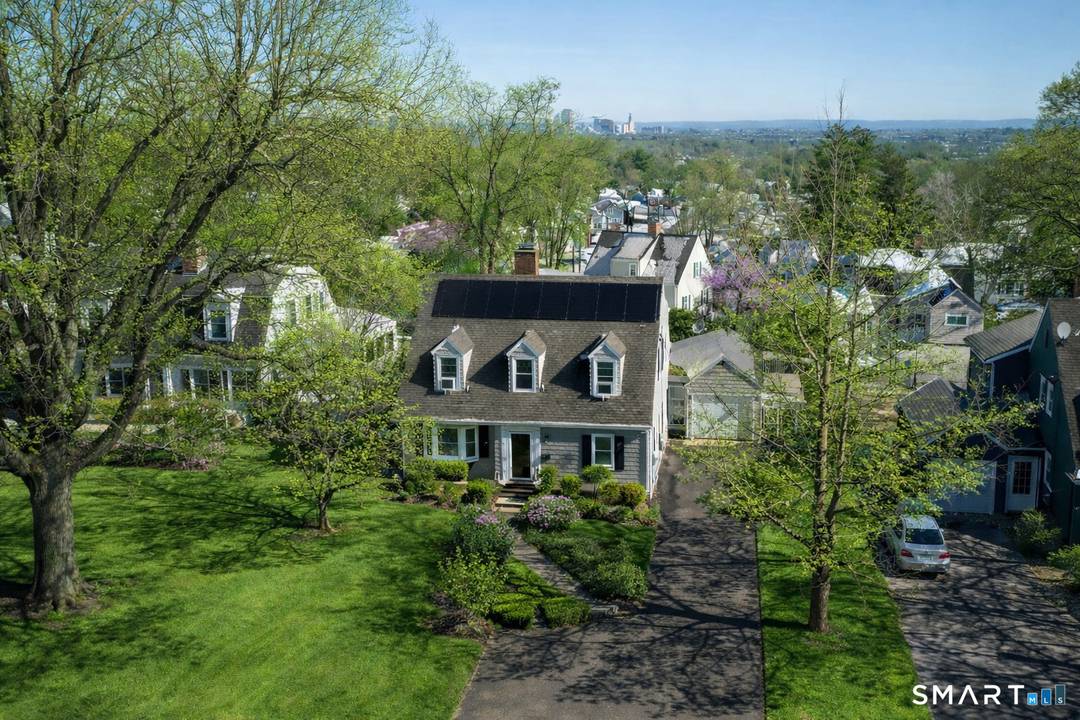 At first glance, it's a classic, quintessential New England Cape Cod home, replete with it's treble dog house dormers.
