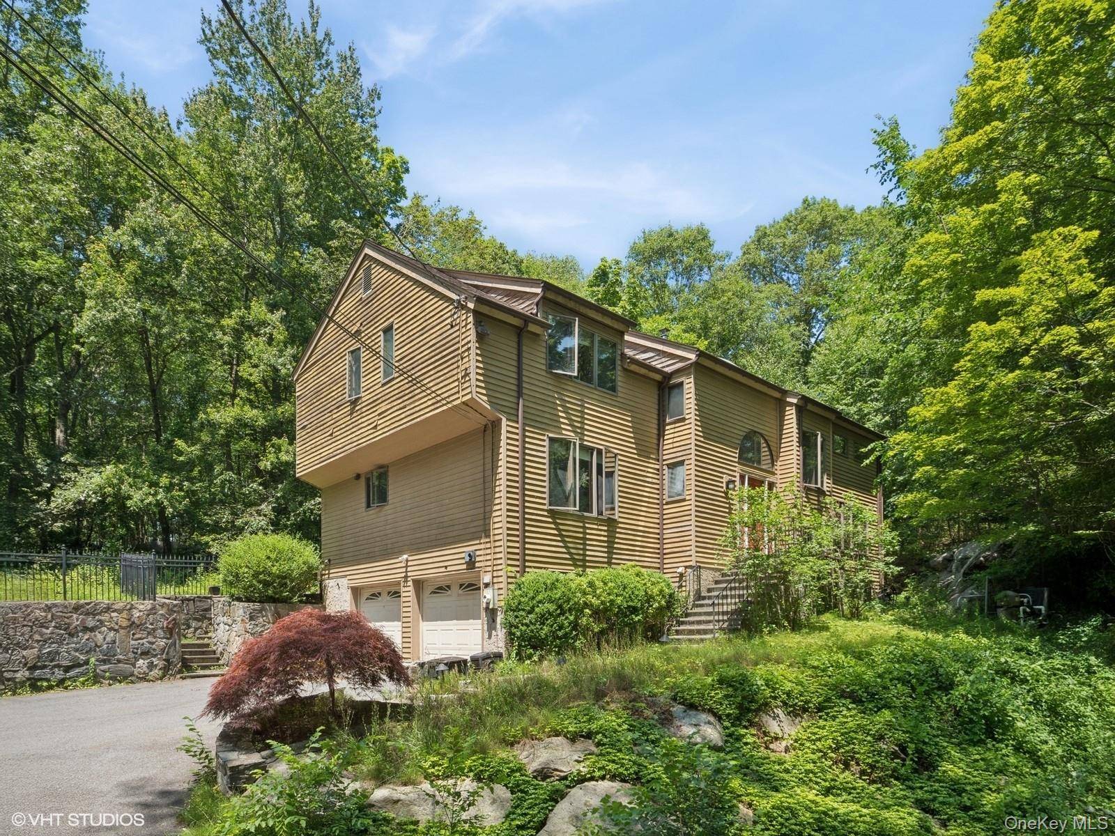 Tucked away on a quiet, wooded lane, this contemporary retreat is all about the setting private, peaceful, and naturally dramatic.