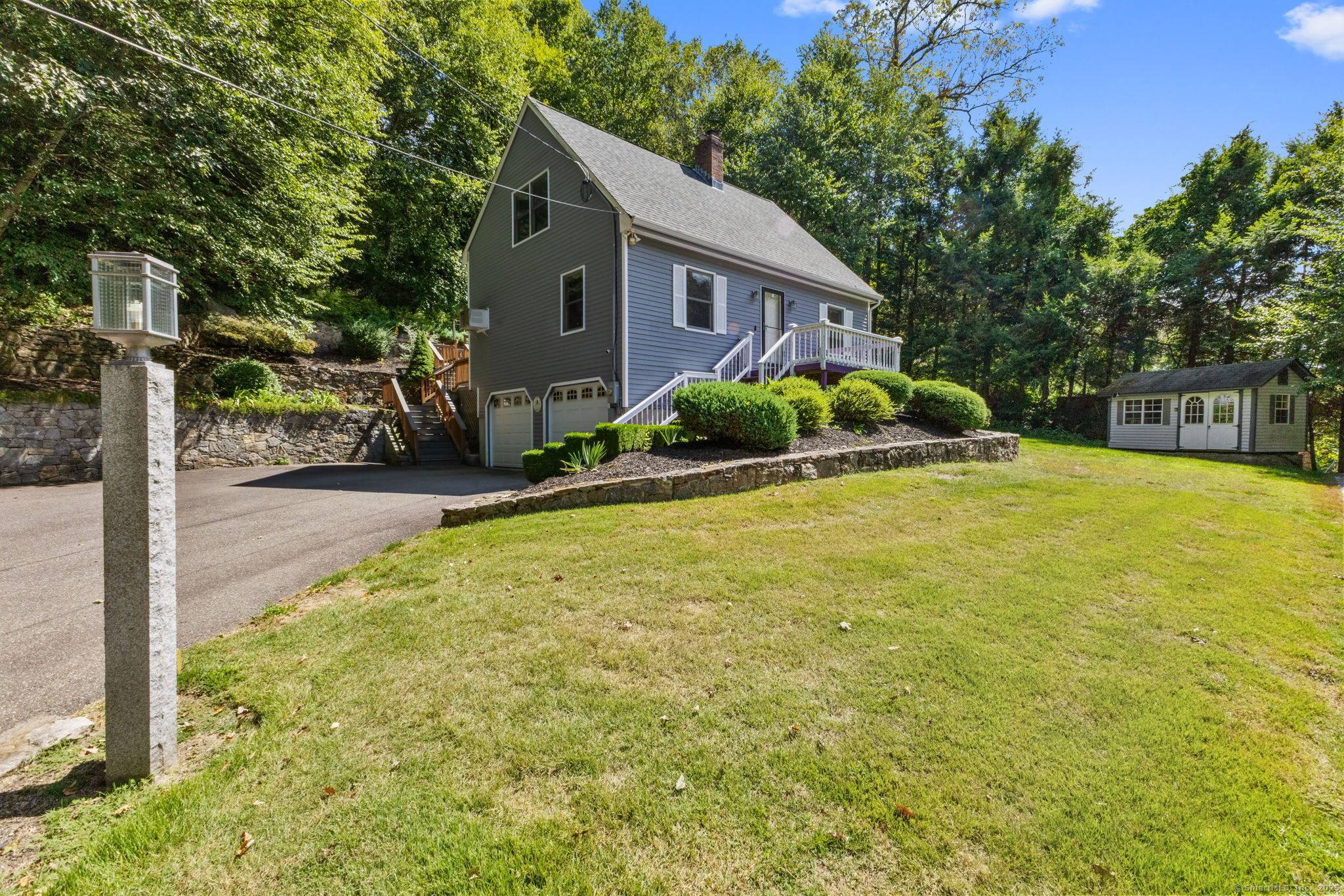 Sunny updated open floor plan Cape Cod set on landscaped.