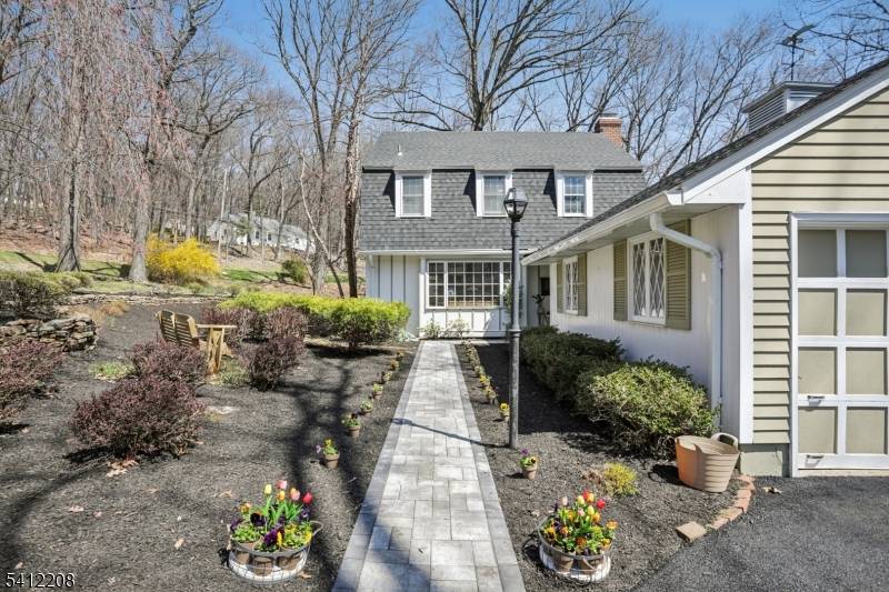 This Puddingstone Heights home offers sophisticated living on an open, wooded lot on private grounds with mature landscaping.