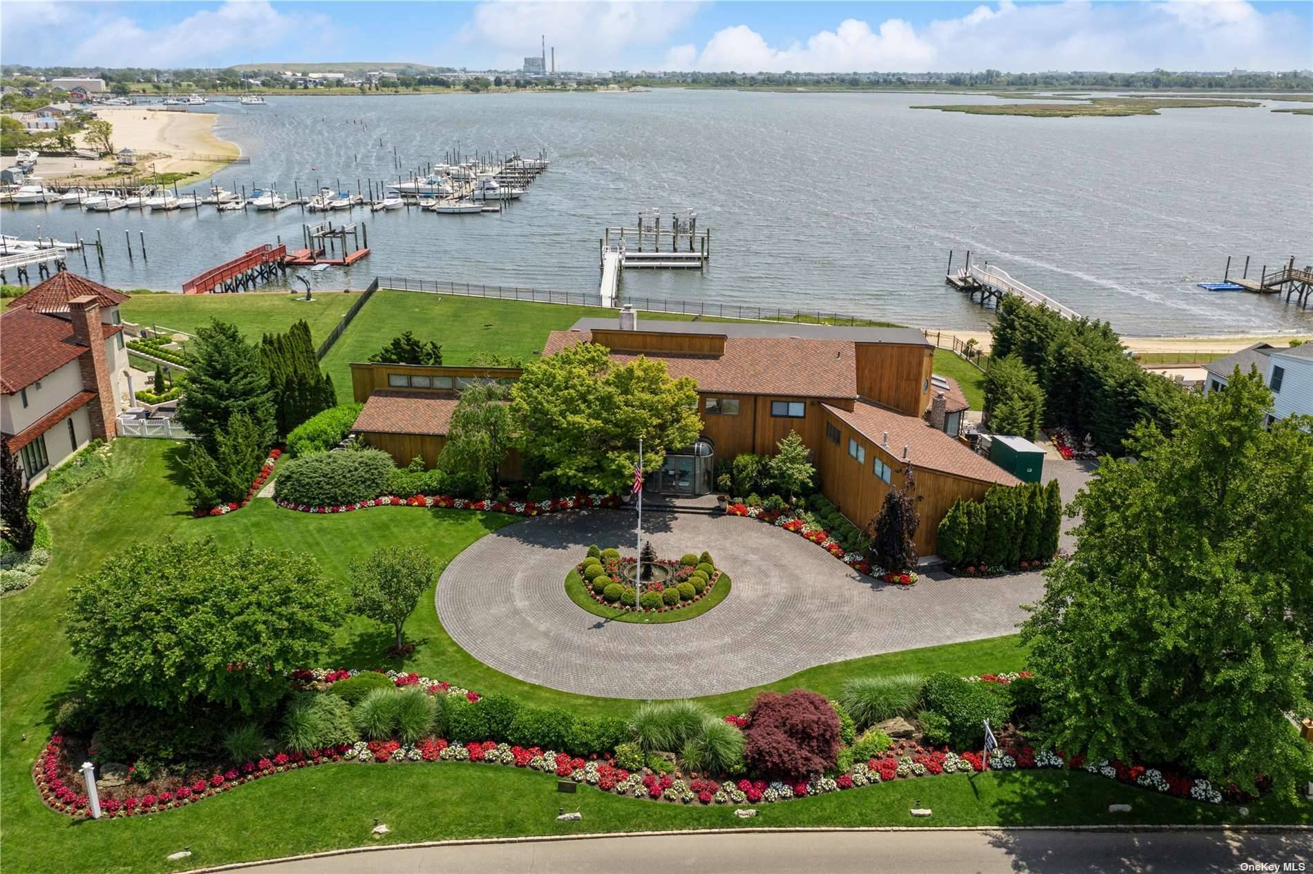Welcome to this extraordinary waterfront contemporary located in picturesque Hewlett Harbor.