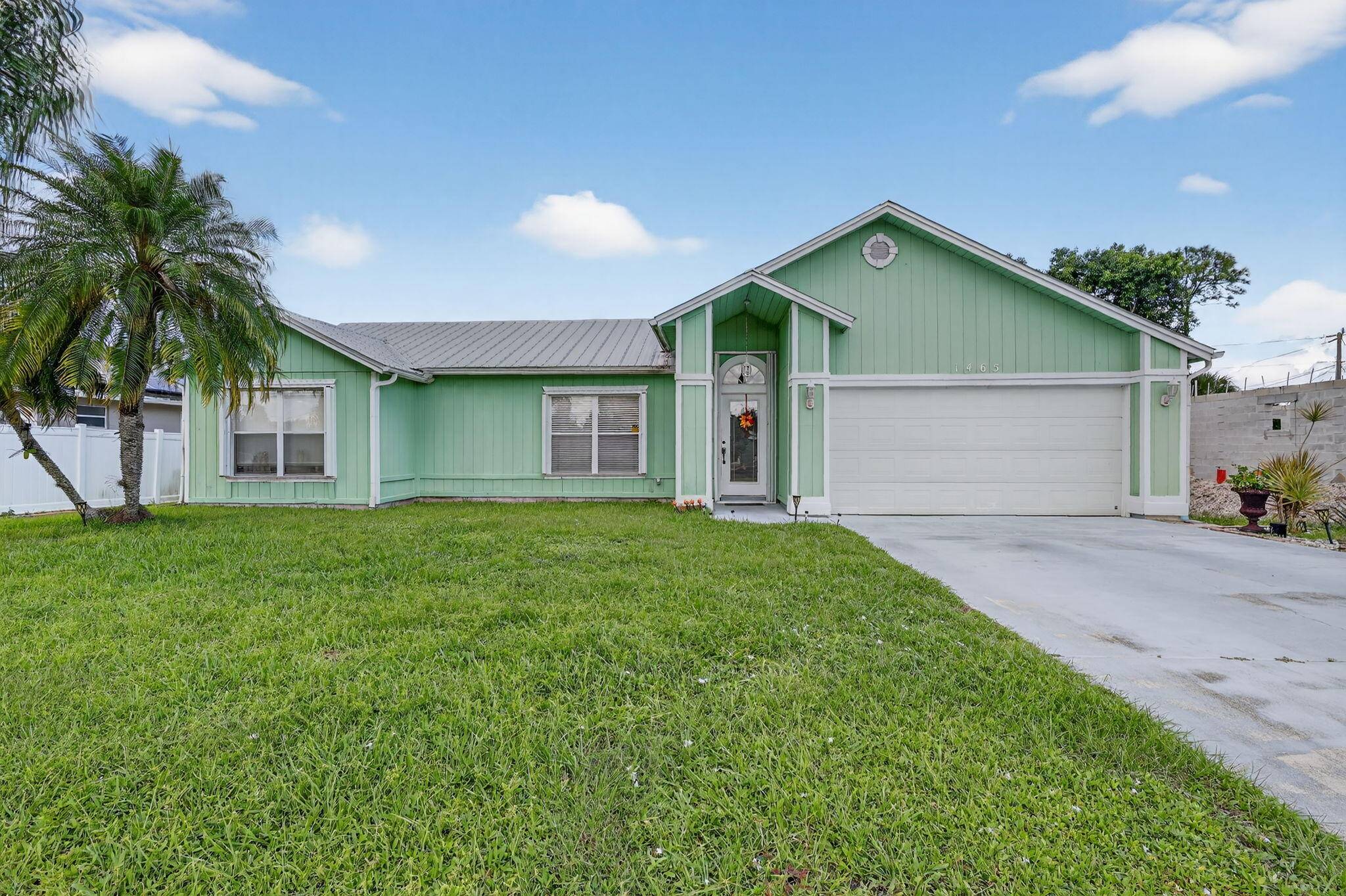 Spacious and inviting 3 bedroom, 2 bath pool home featuring a durable metal roof and an open floor plan with high ceilings and abundant natural light.