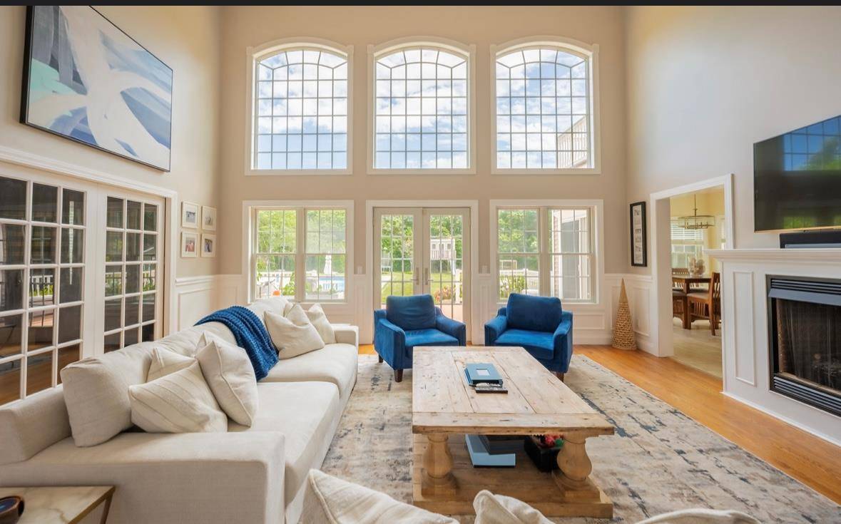 Drive down a picturesque, tree lined driveway and arrive at this stunning post modern home nestled on a spacious, 1.