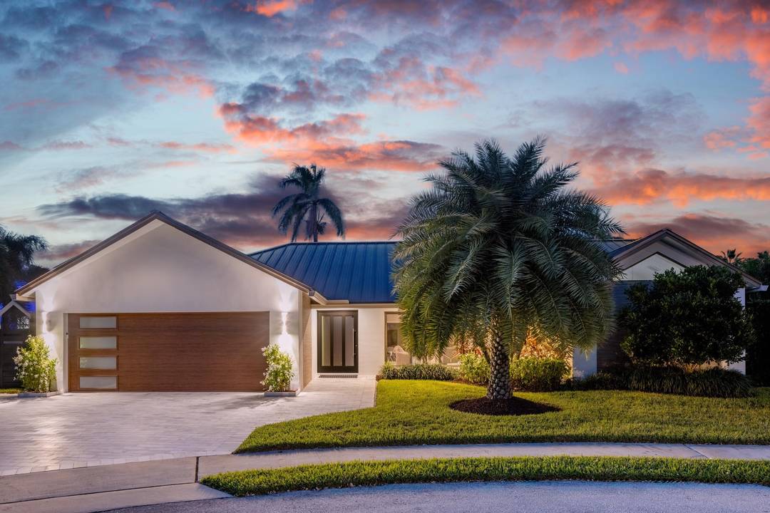 One story captivating custom contemporary home in Boca Bay Colony, a highly esteemed waterfront community.