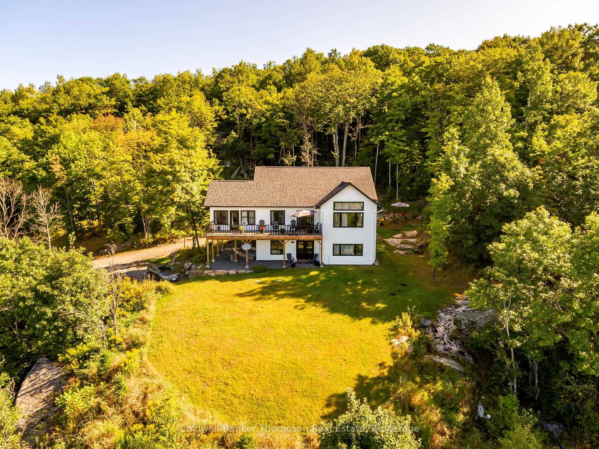 Welcome to your dream home, a stunning bungalow with a walkout basement, set on 5 peaceful acres just minutes from Port Sydney.