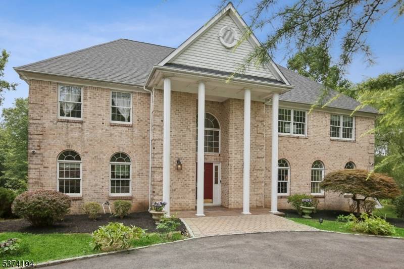 Enter through the circular driveway to this beautifully appointed colonial, where timeless charm meets modern comfort.