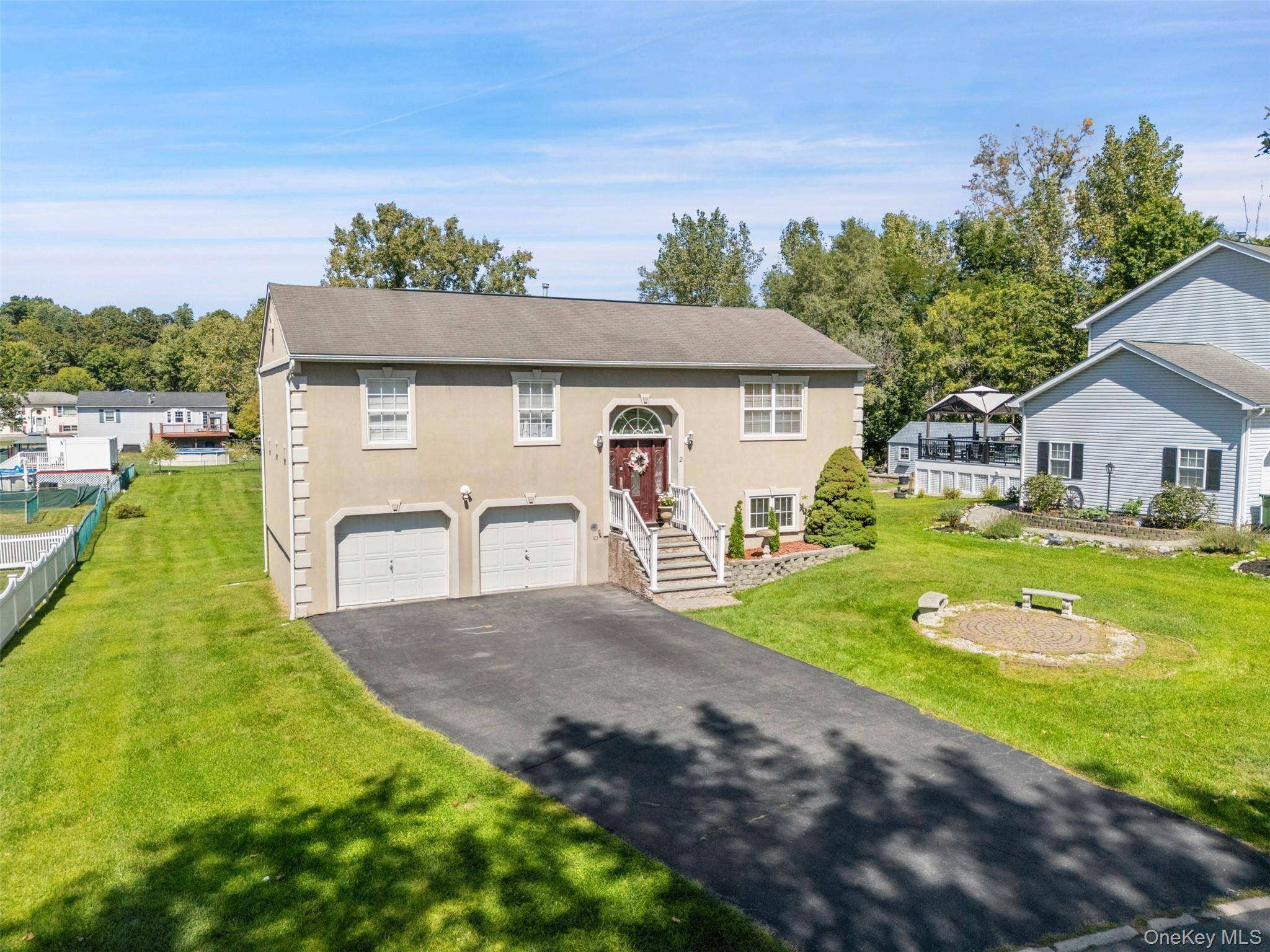 Welcome to 2 Danielle Court, a stucco home on just over a half acre in desirable Middletown, NY.