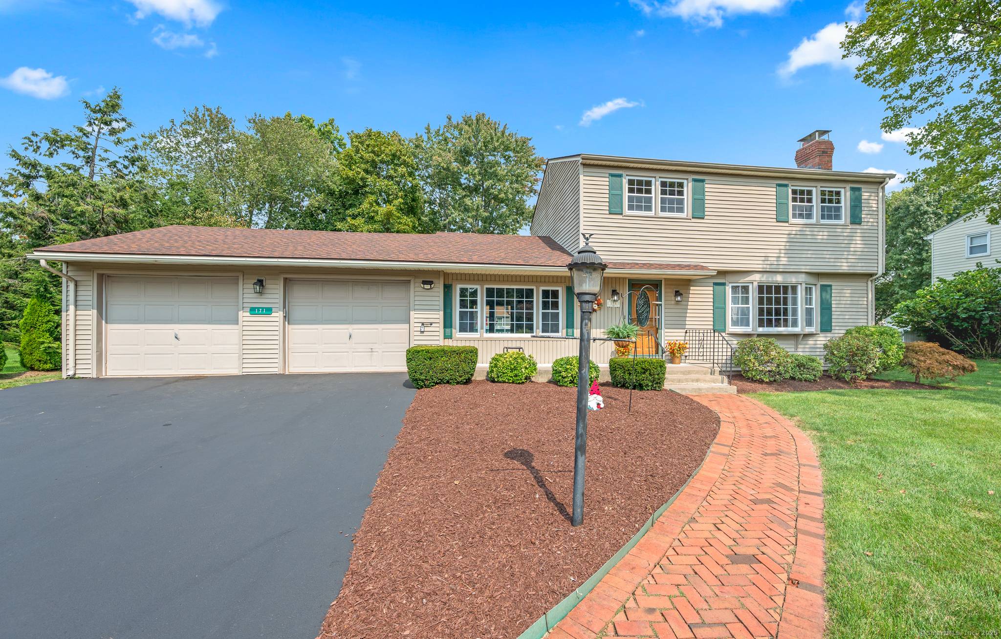 Beautiful curb appeal and a sidewalk lined neighborhood nestled in Glastonbury greets every greets every guest.