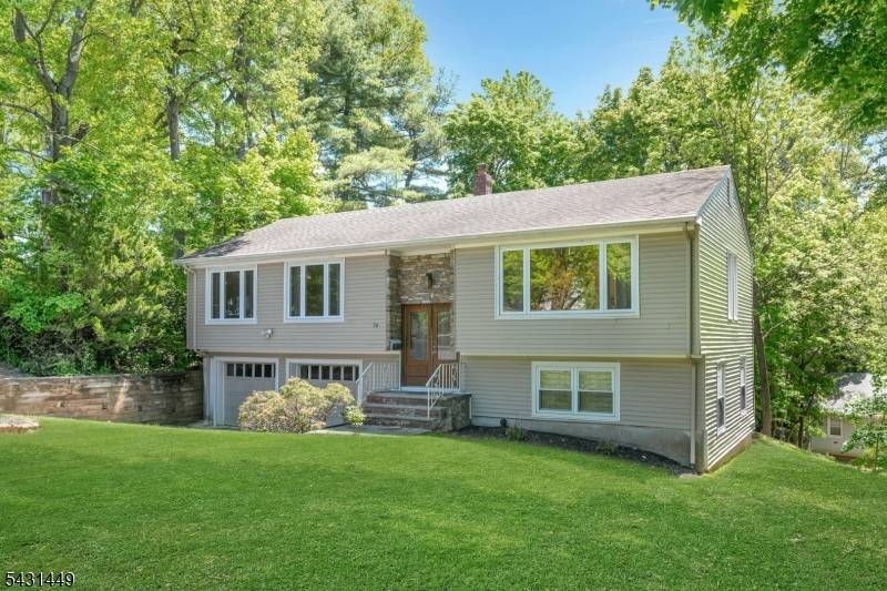Stylish and well maintained Collins bi level home featuring hardwood floors, oversized windows, and abundant natural light throughout.