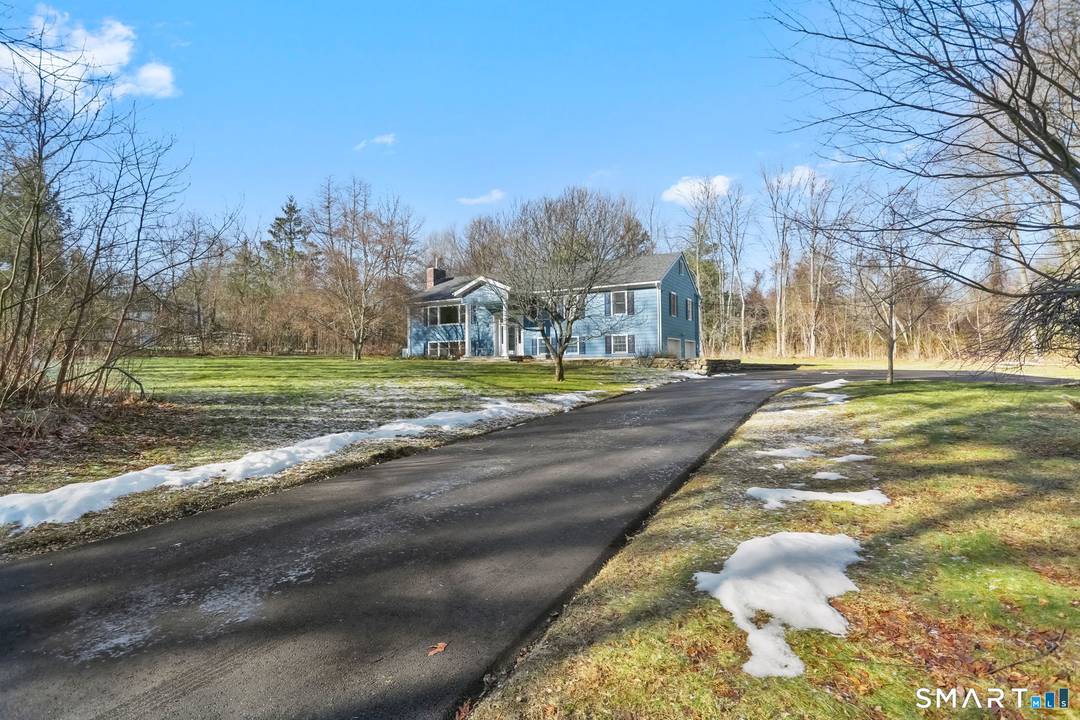 Set on a level, corner acre plus lot in the historic Silvermine neighborhood bordering New Canaan this fully renovated Raised Ranch offers elevated living in a timeless setting.