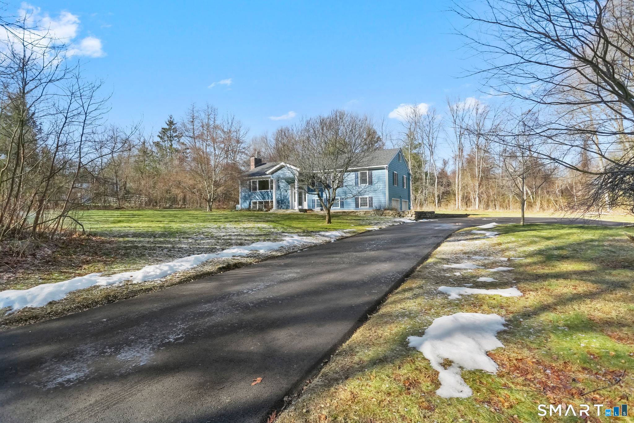 Set on a level, corner acre plus lot in the historic Silvermine neighborhood bordering New Canaan this fully renovated Raised Ranch offers elevated living in a timeless setting.