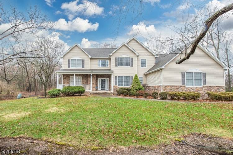 Impressive 5 bedroom, 2. 5 bath Colonial with a welcoming front porch, 3 car attached garage, and beautifully landscaped property.