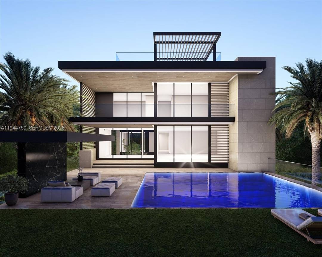 Luxury waterfront home being built with dramatic evening views of the Miami Beach skyline.