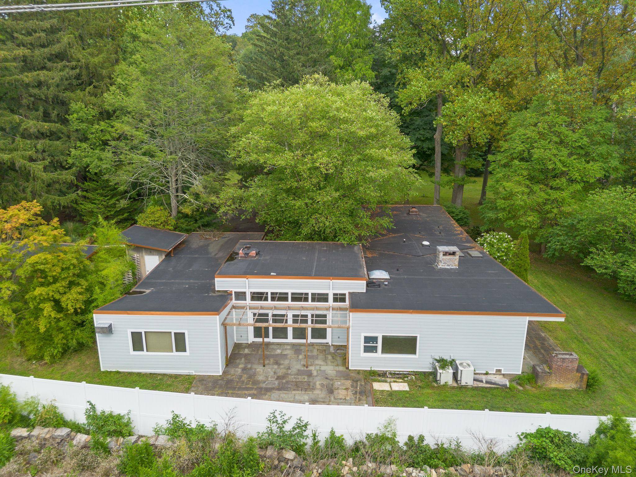 Welcome to this expansive 6 bedroom, 5 bath mid century ranch on nearly 1.