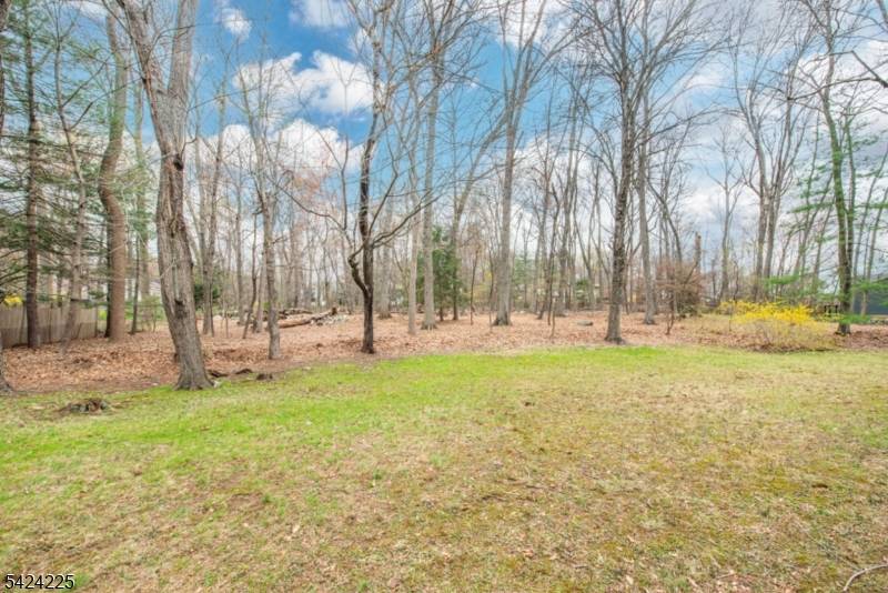 Situated on a unique flat, wooded 1.