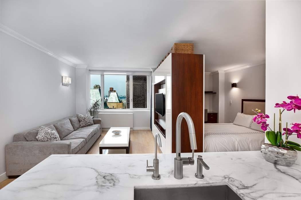 This spacious Alcove studio in the luxurious condominium, The Sheffield offers a large open concept kitchen with white Poliform cabinetry, Calacatta gold marble counter tops and backslash, Miele dishwasher, Sub ...