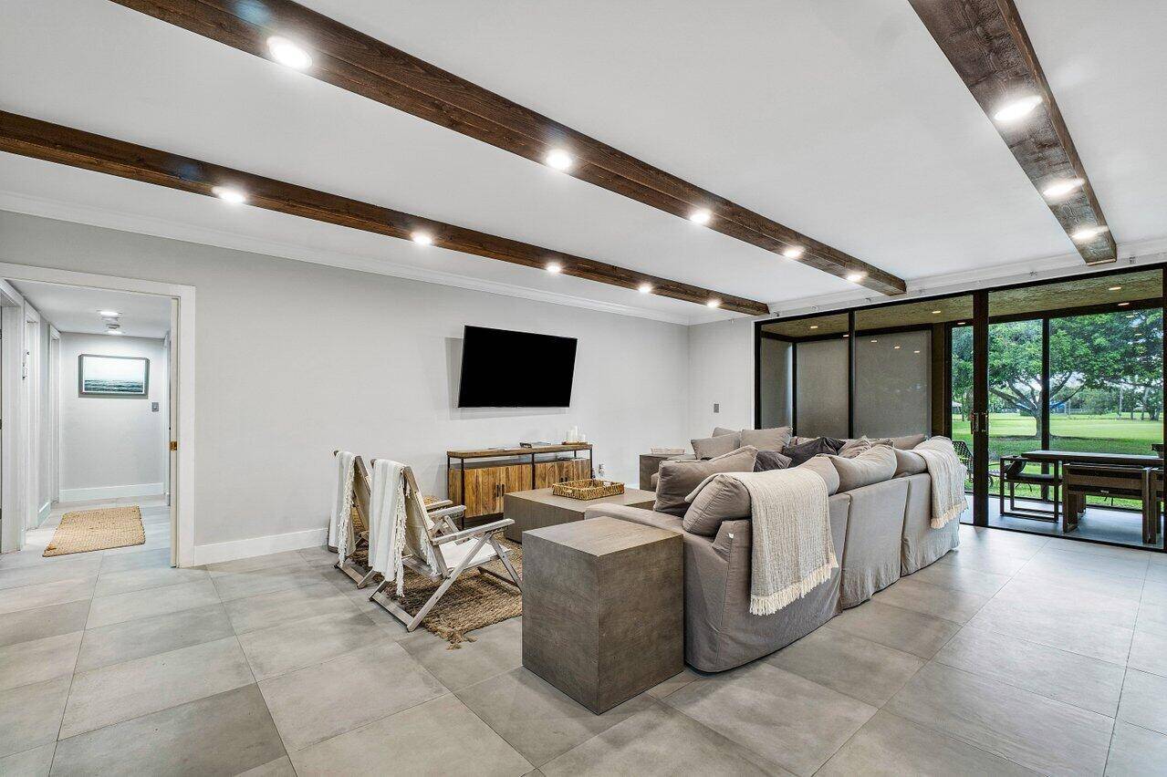 This beautifully renovated ground floor condo is located on Polo Island Drive, where majestic Banyan trees greet you upon arrival.
