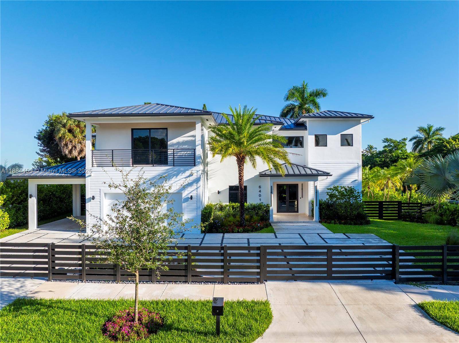 This new construction, South Miami estate redefines modern luxury.