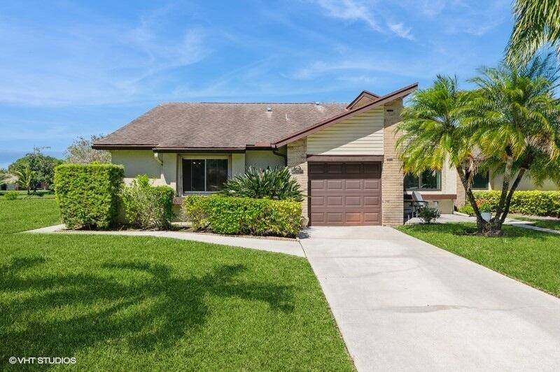 Peaceful and spacious 3 bedroom corner villa with expansive views featuring two canals and an enormous lawn maintained by the HOA.