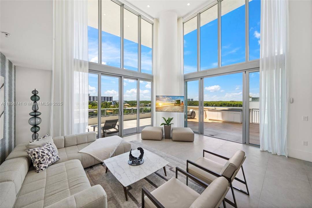 One of a kind, two level corner residence where light filled interiors meet sleek modern design and floor to ceiling windows frame incredible water views from every room.