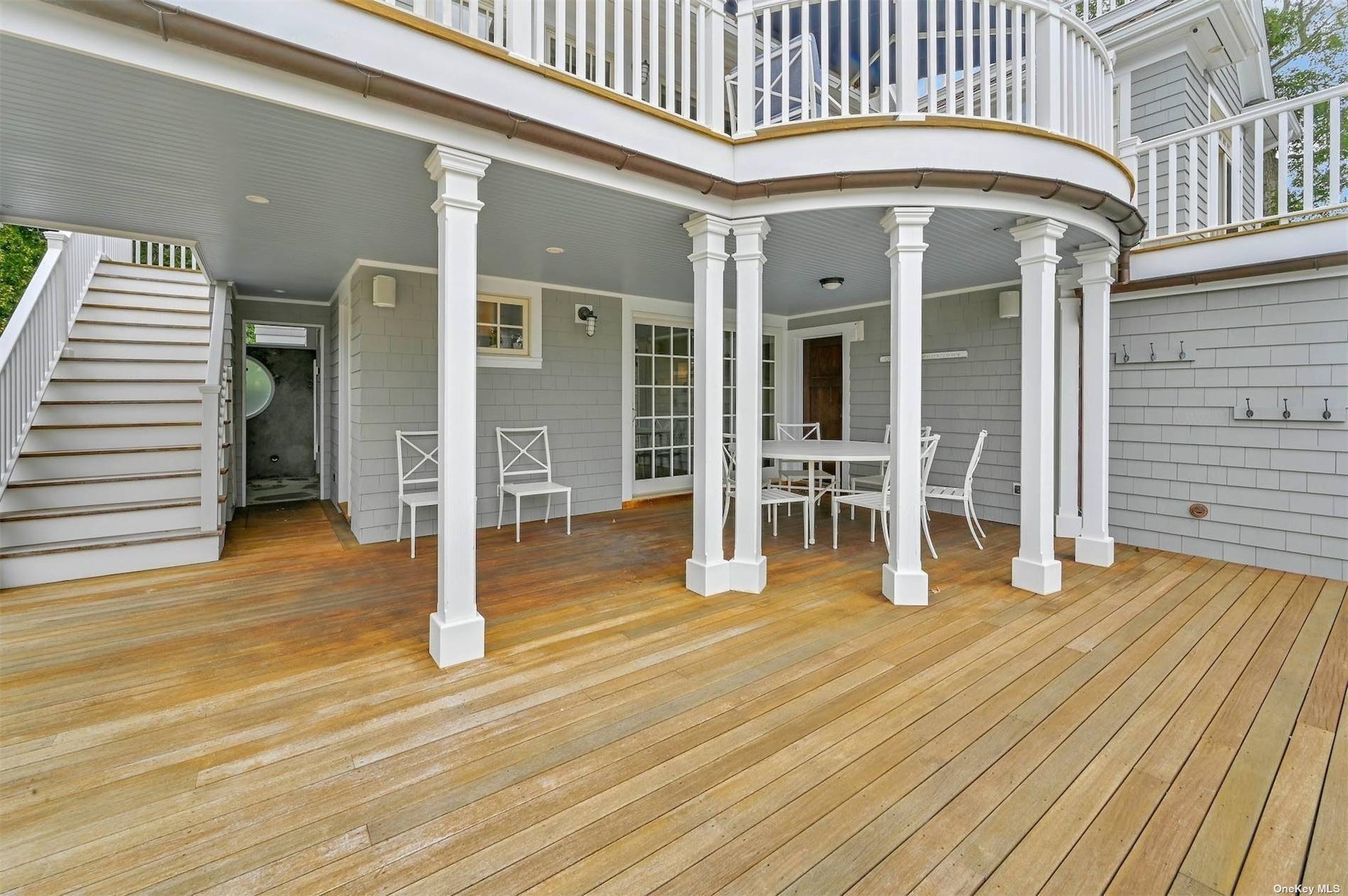 This custom built Nantucket style home is nestled at the end of a long gated driveway, offering unparalleled privacy and captivating western views over Quantuck Creek.