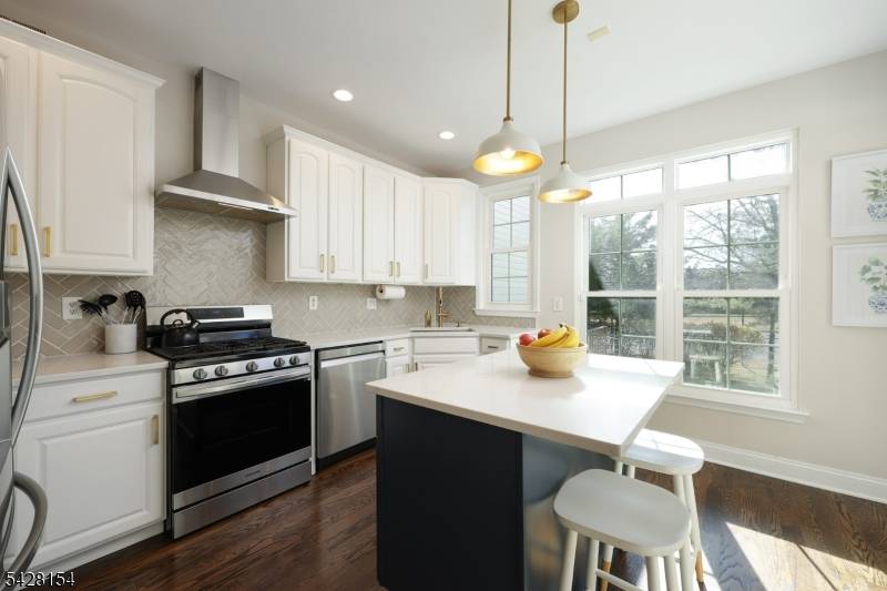 Step into light filled elegance in this beautifully maintained Martinsville townhome, where soaring 2 story ceilings and rich hardwood floors create an immediate sense of space and style.