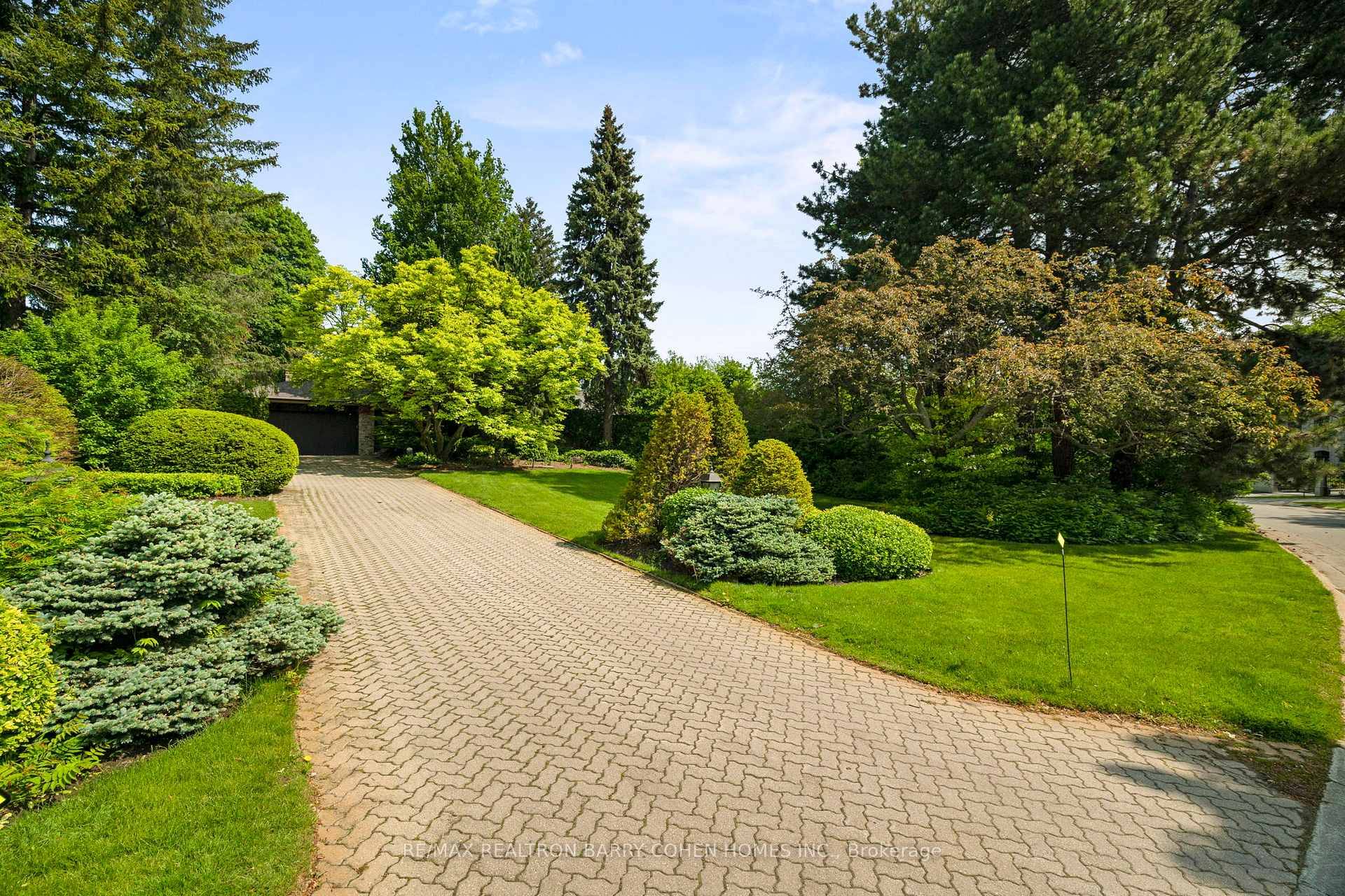 Sprawling Stone Faced Bungalow In The Prestigious York Mills Neighbourhood Surrounded By Lush Landscaping On An Irregular Shaped Lot.
