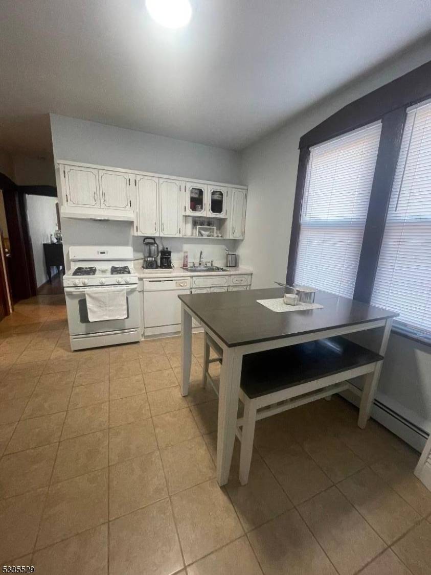 Spacious 2 Family Home with Bonus Lot Ideal Location Near Rt 46Welcome to this very large 2 family home, perfect for both investors and owner occupied.