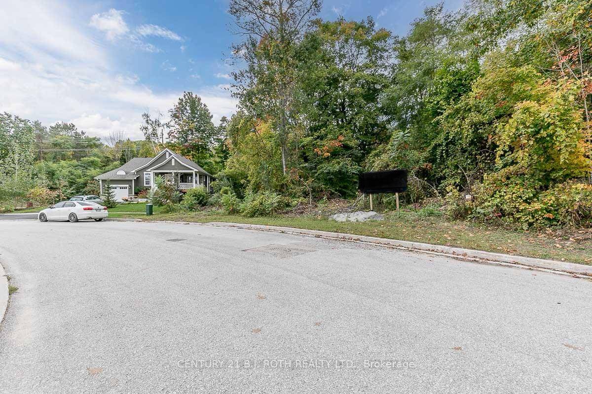 Midland Build your dream home on a spacious, treed lot steps from Georgian Bay in this sought after neighbourhood of executive homes On street hydro, municipal water and sewer.