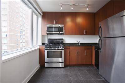 Spacious two bedroom apartment featuring a bright, open layout with a windowed kitchen and a generously sized living room.