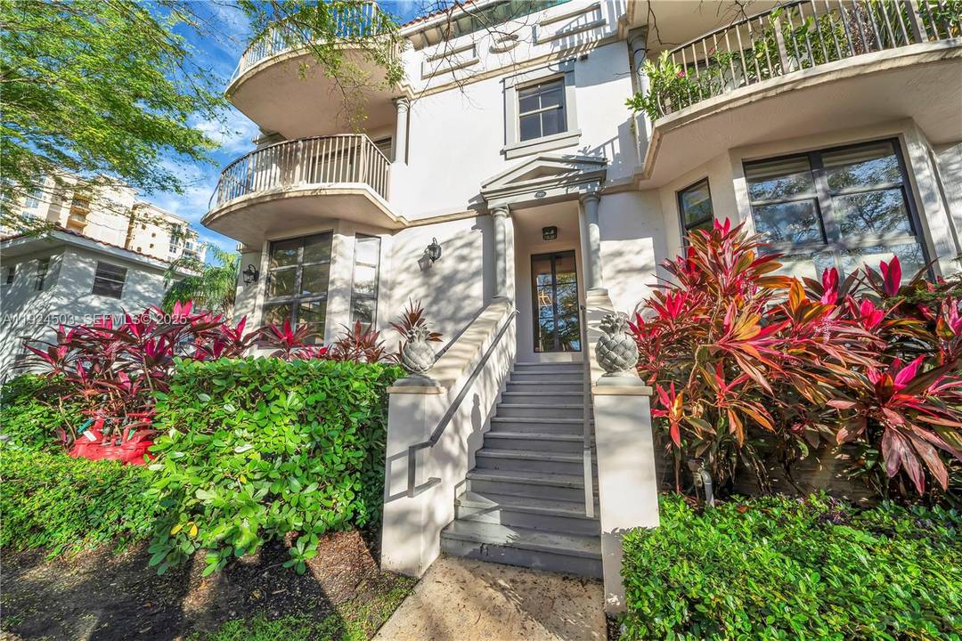 Discover this updated modern corner townhouse nestled in a boutique style community on a picturesque, tree lined street just an easy 8 minute walk to Giralda Avenue and Miracle Mile.