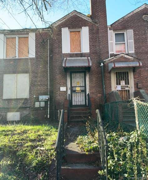 Semi detached corner brick two family in poor condition.