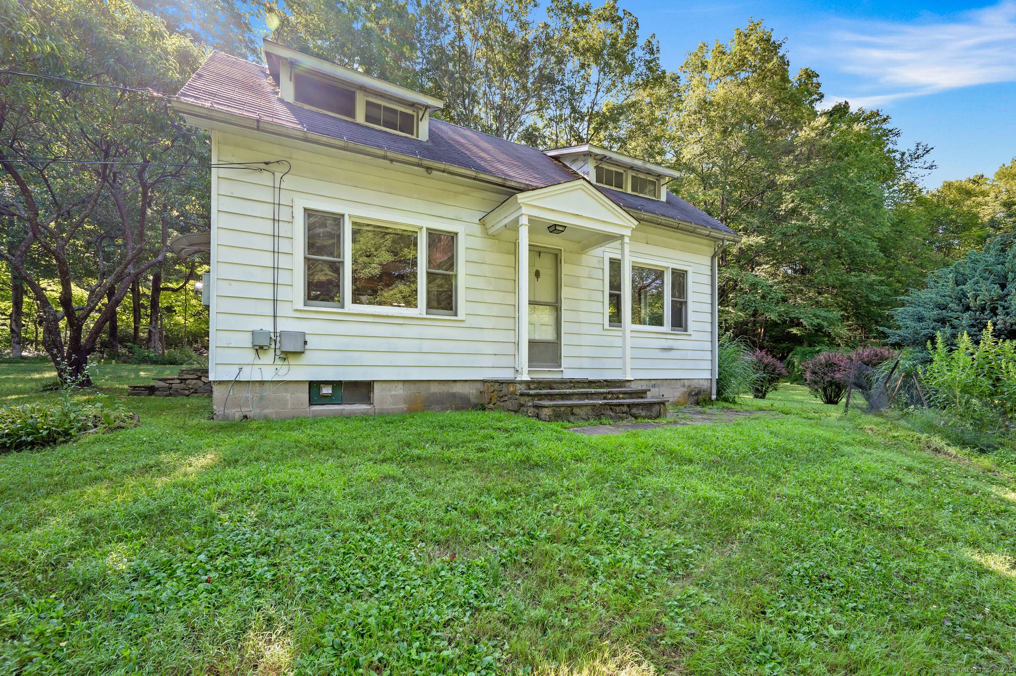 Private and charming 2 bedroom Country Cape located on 2 very pretty acres of private and landscaped property.