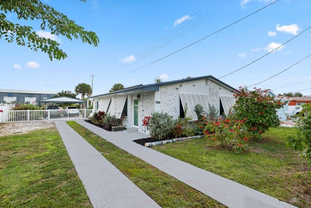 Upscale WATERFRONT home with mid century flair in the hidden gem of Melaleuca Gardens !