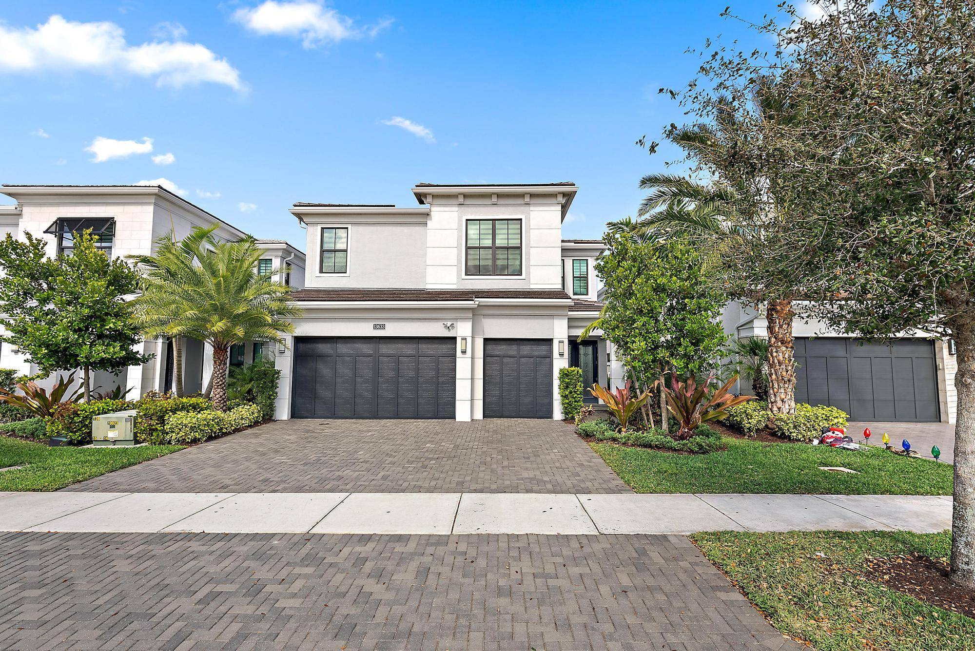 This exceptional LAKE FRONT Hudson model is a true showcase property located in the private, gated community of Artistry Palm Beach.