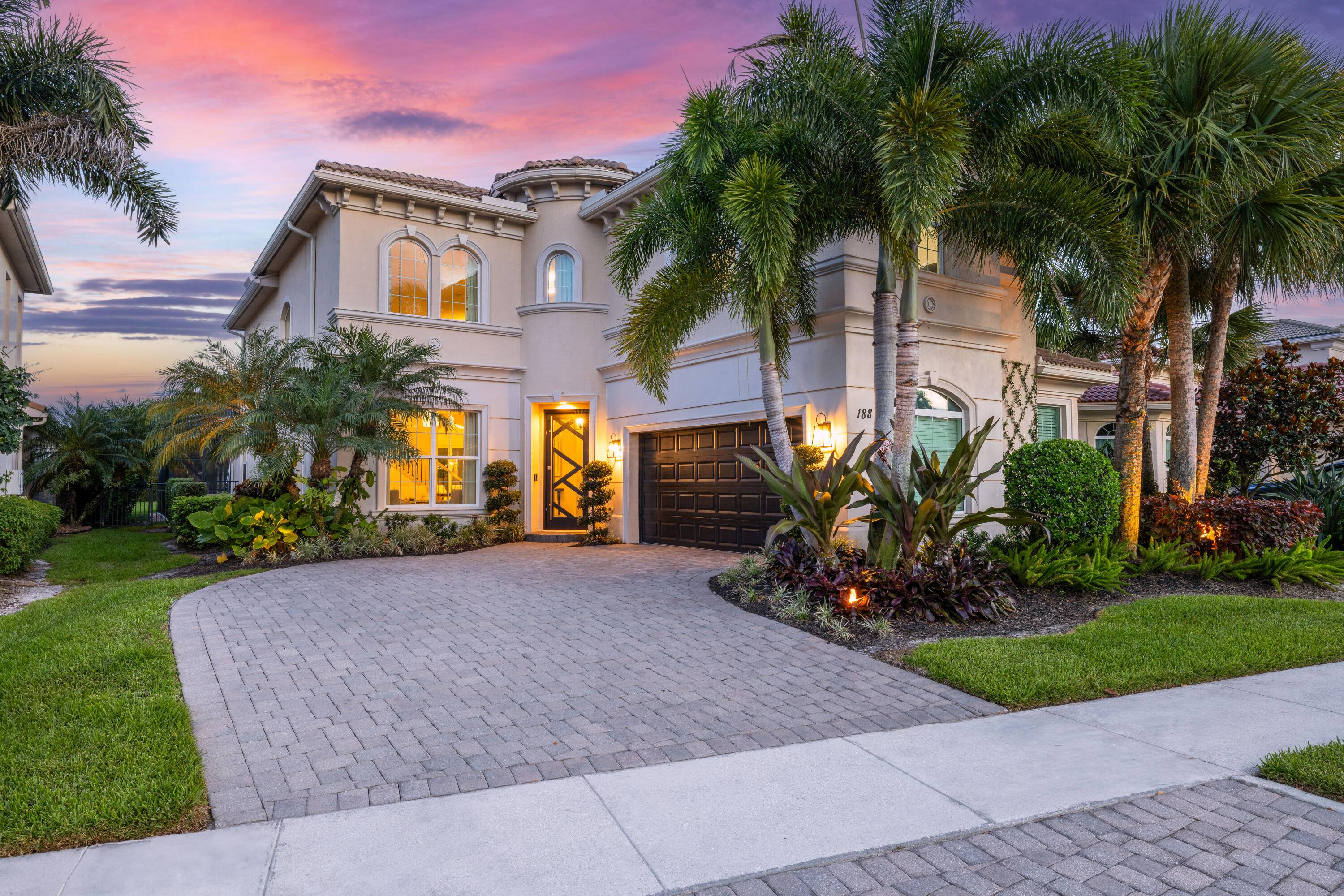 Welcome to 188 Carina Drive, a beautifully updated and meticulously maintained residence located in the prestigious Jupiter Country Club.