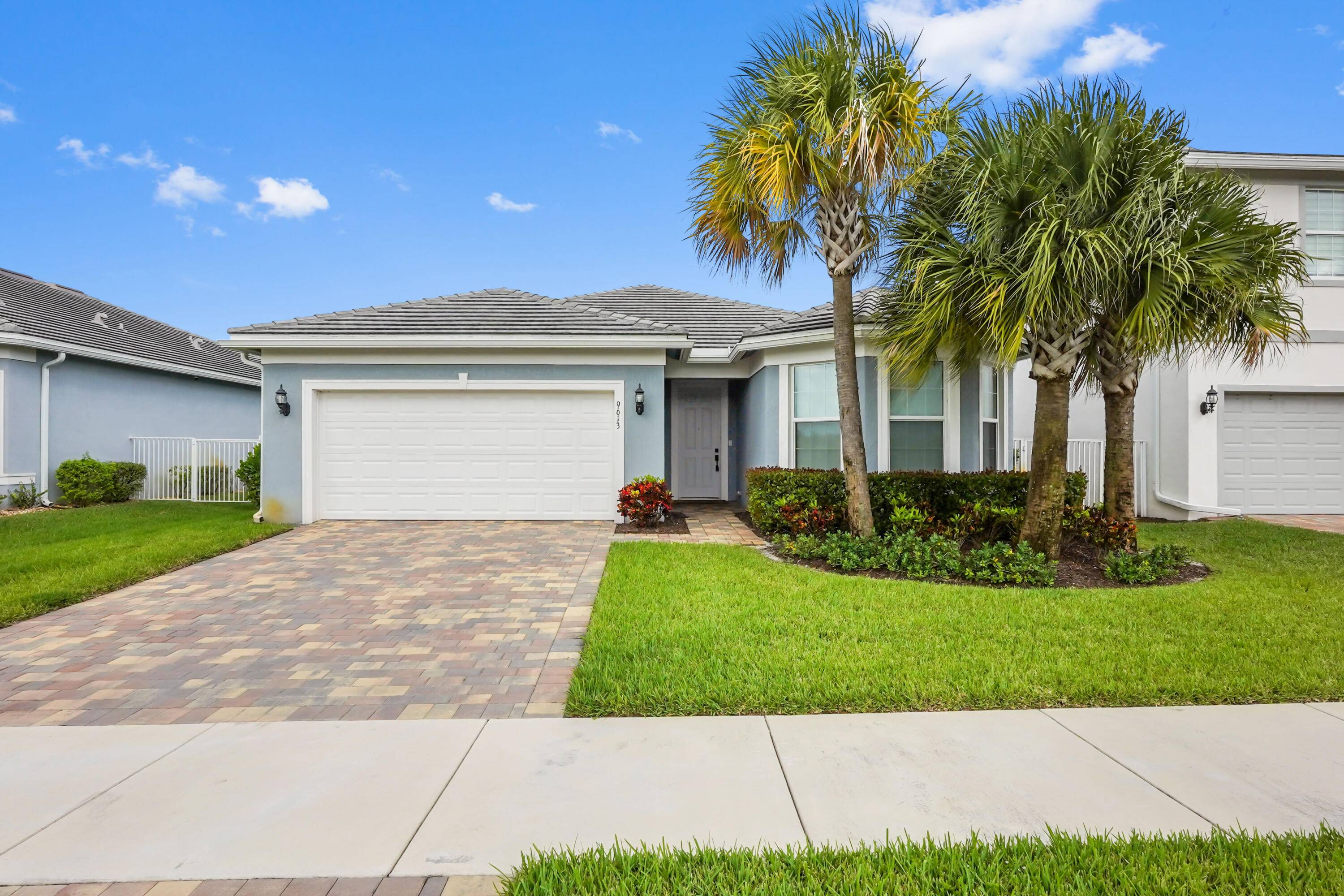 Prepare to be impressed by this absolutely stunning and meticulously upgraded single family pool home, perfectly situated in the desirable, lake focused community of Windsong Estates in Lake Worth.