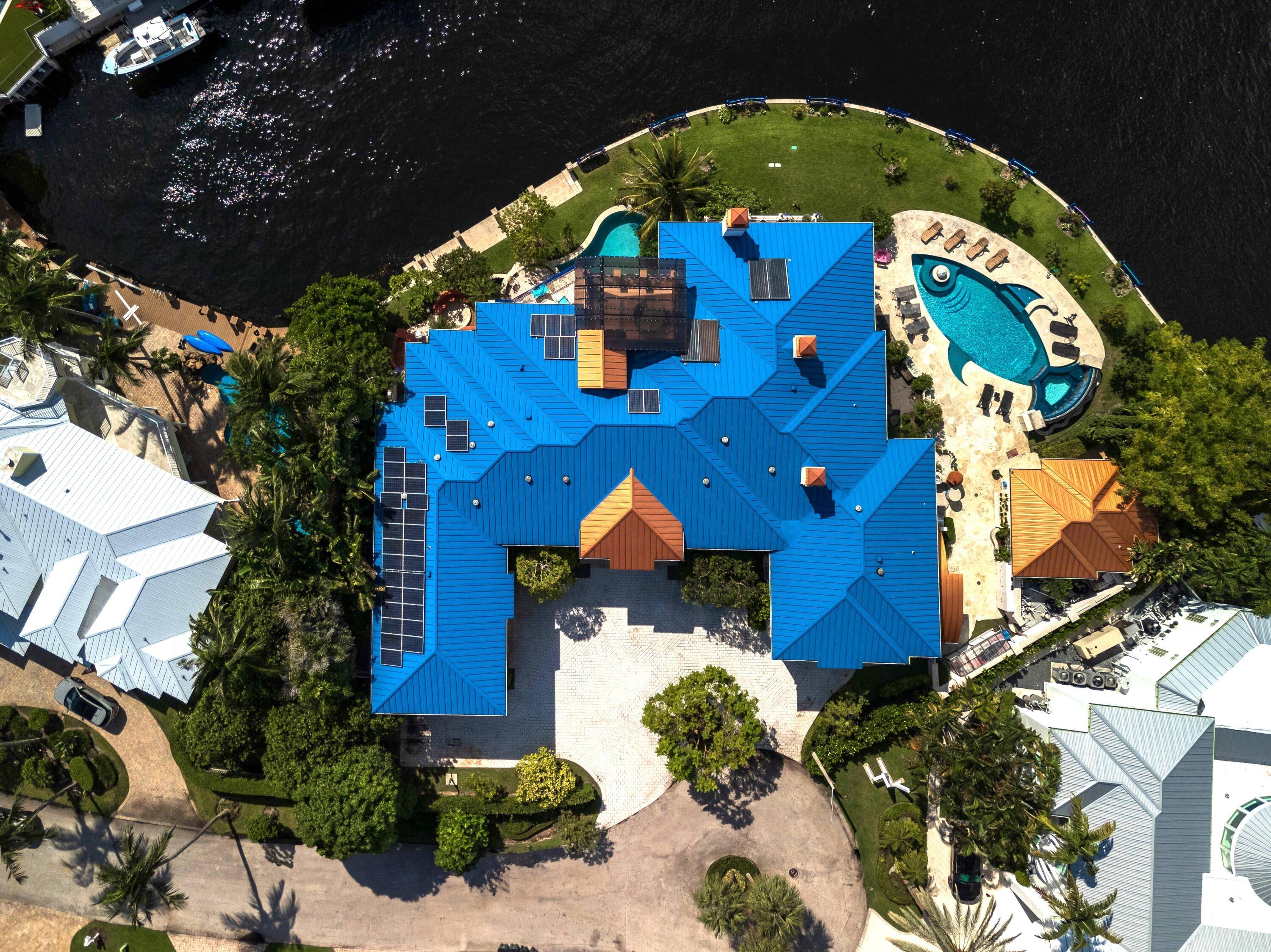 This Magnificent Estate is truly a Work of Art and situated on a Direct Intracoastal Point Lot with 256 ft of Waterfrontage and.