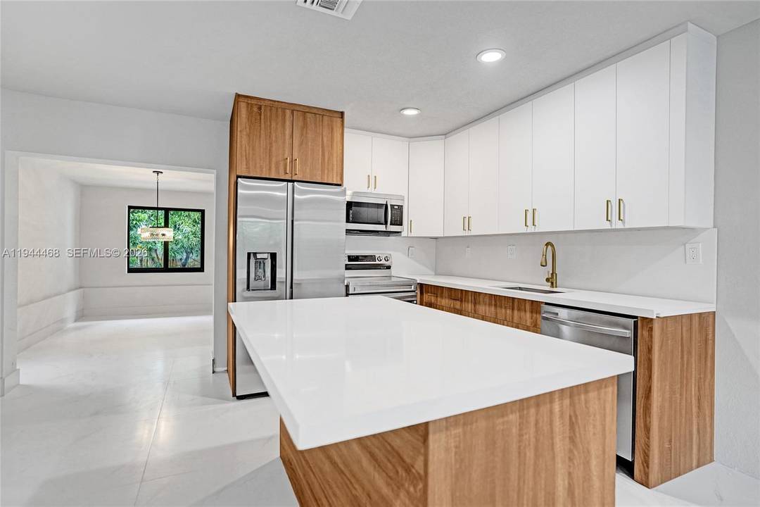 Exquisite remodeled 5 bedroom, 3 bathroom home featuring a private in law suite and impact windows throughout.