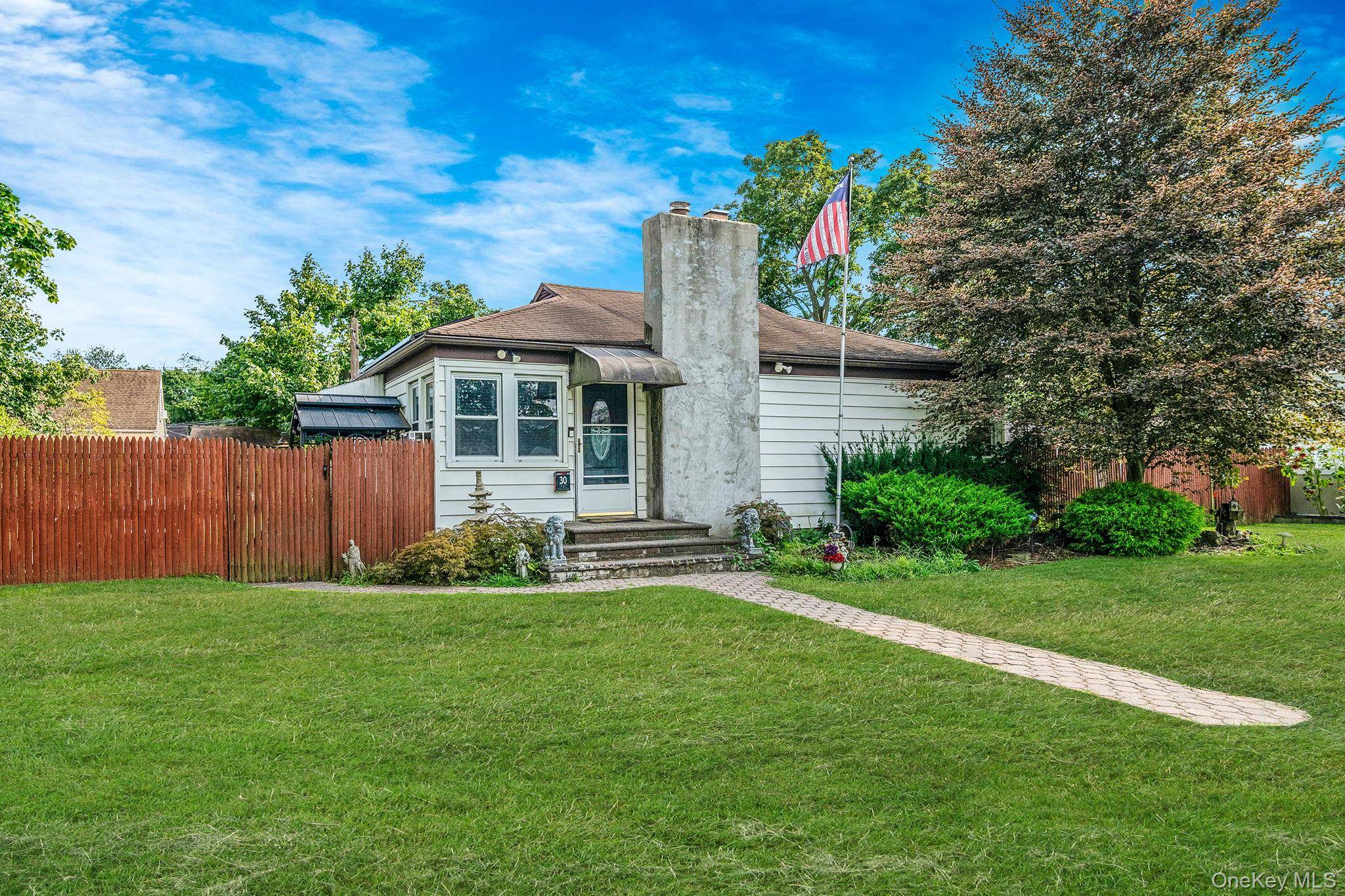 This immaculately maintained two bedroom ranch in the heart of Central Islip is the brimming with personality and perfectly situated on an oversized lot.