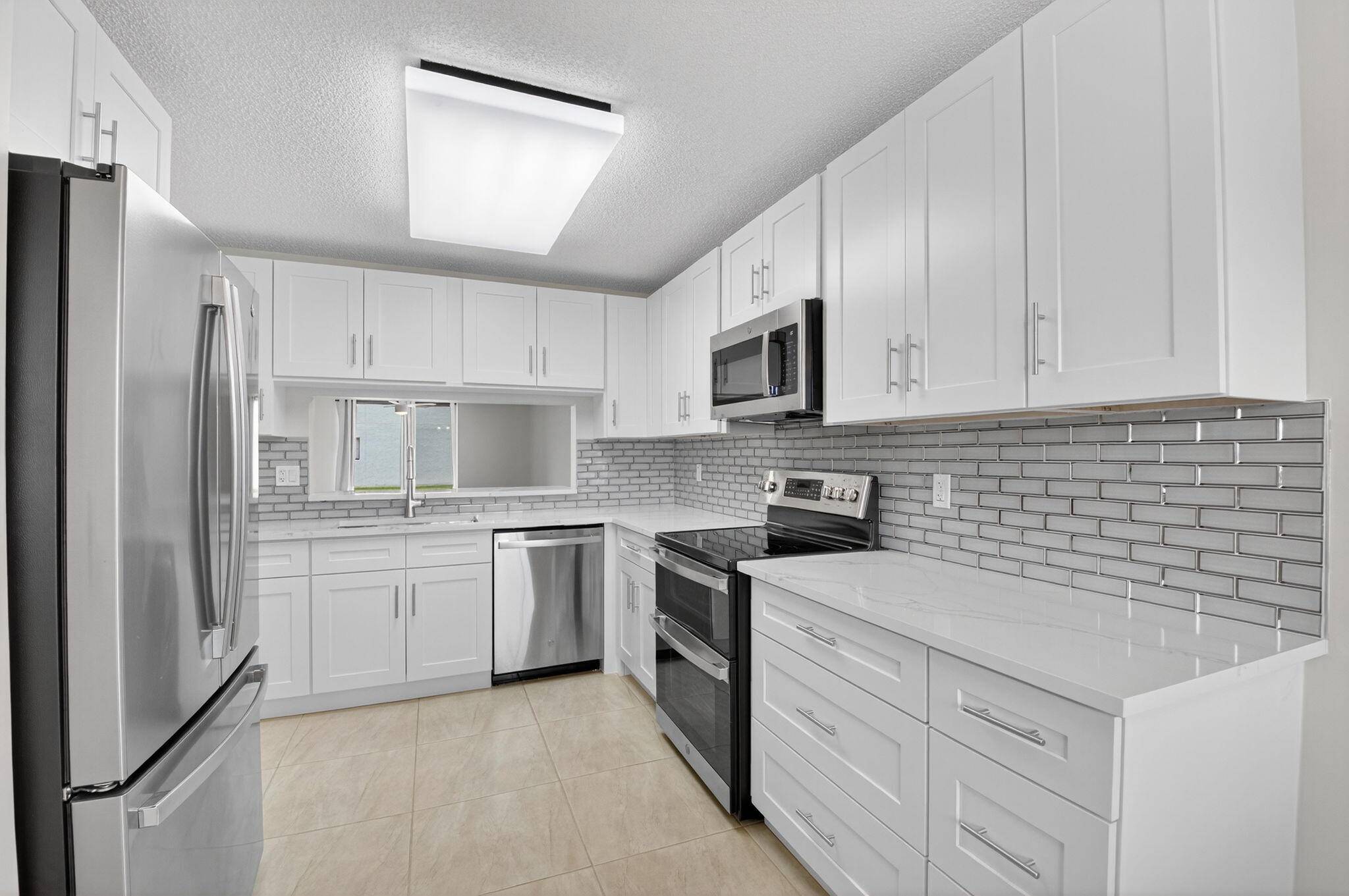 Fully Renovated Ground Floor Condo in Watersedge at Lakes of Delray.