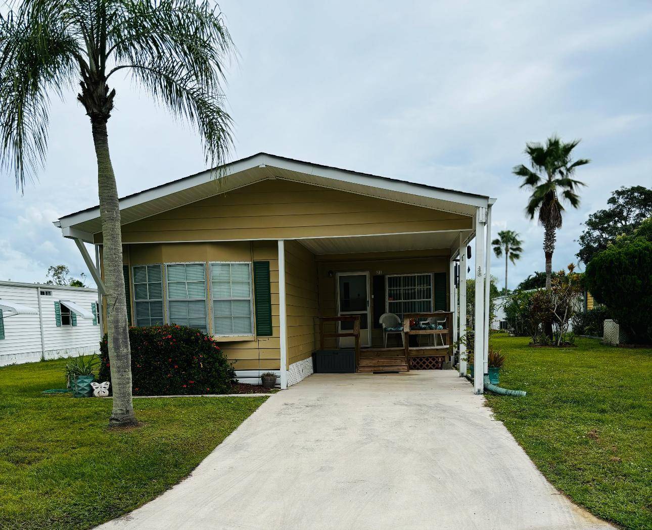 Step into this spacious mobile home located in Spanish Lakes Golf Village, an active 55 community offering a wealth of amenities.