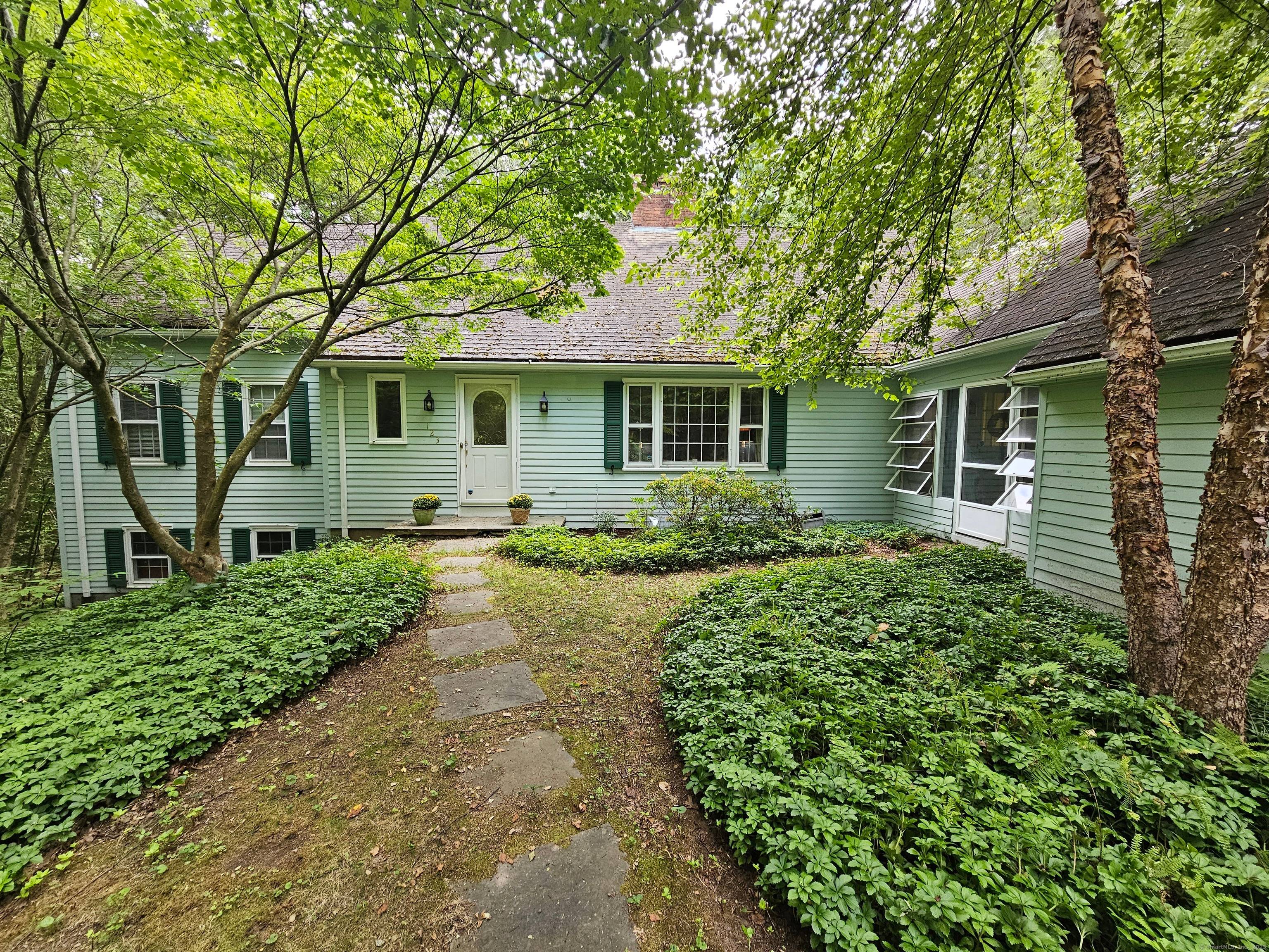 Set well back from the street on more than two picturesque acres on sought after Reverknolls !